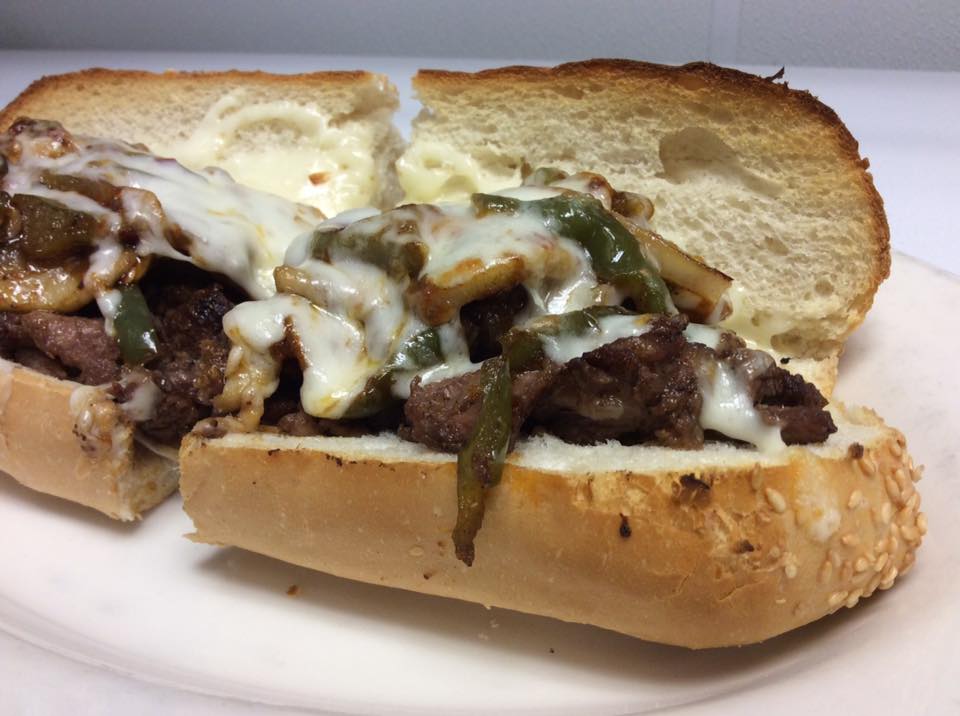 Italian sausage sandwich with peppers and melted cheese